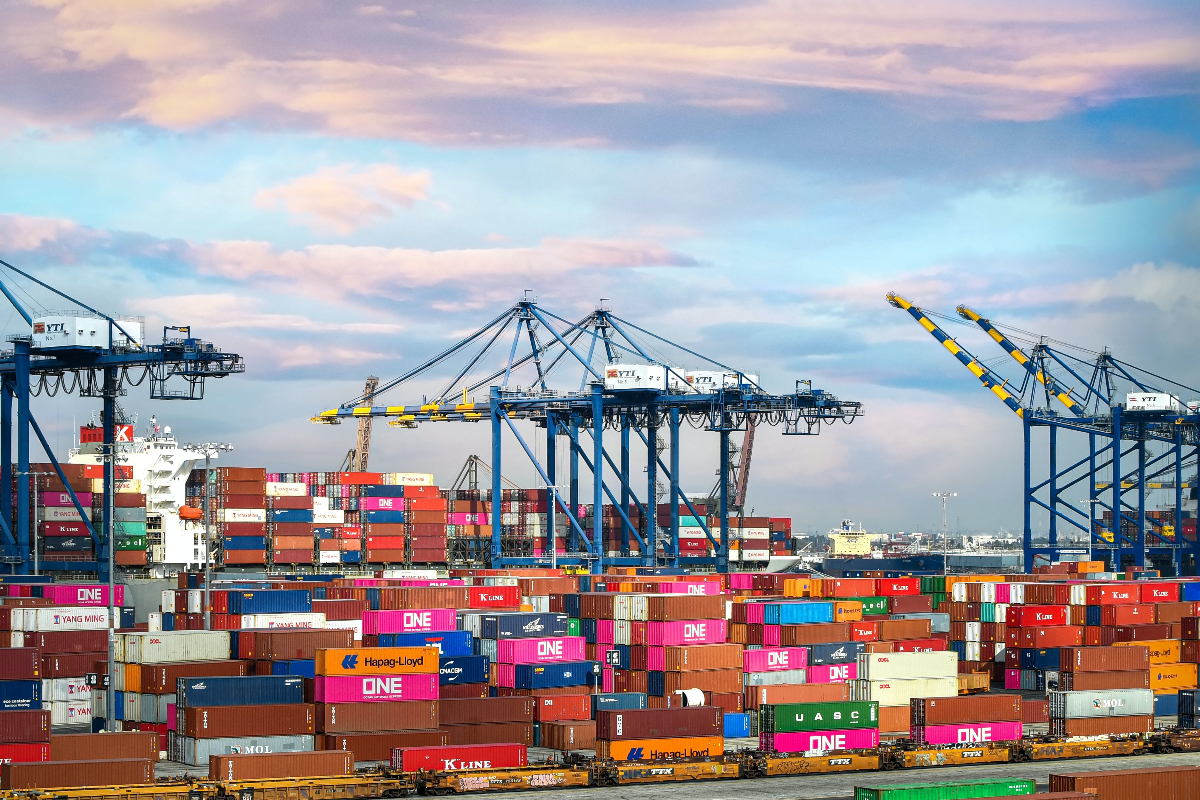 Mother Vessel carrying thousand shipping containers from multiple feeder vessels